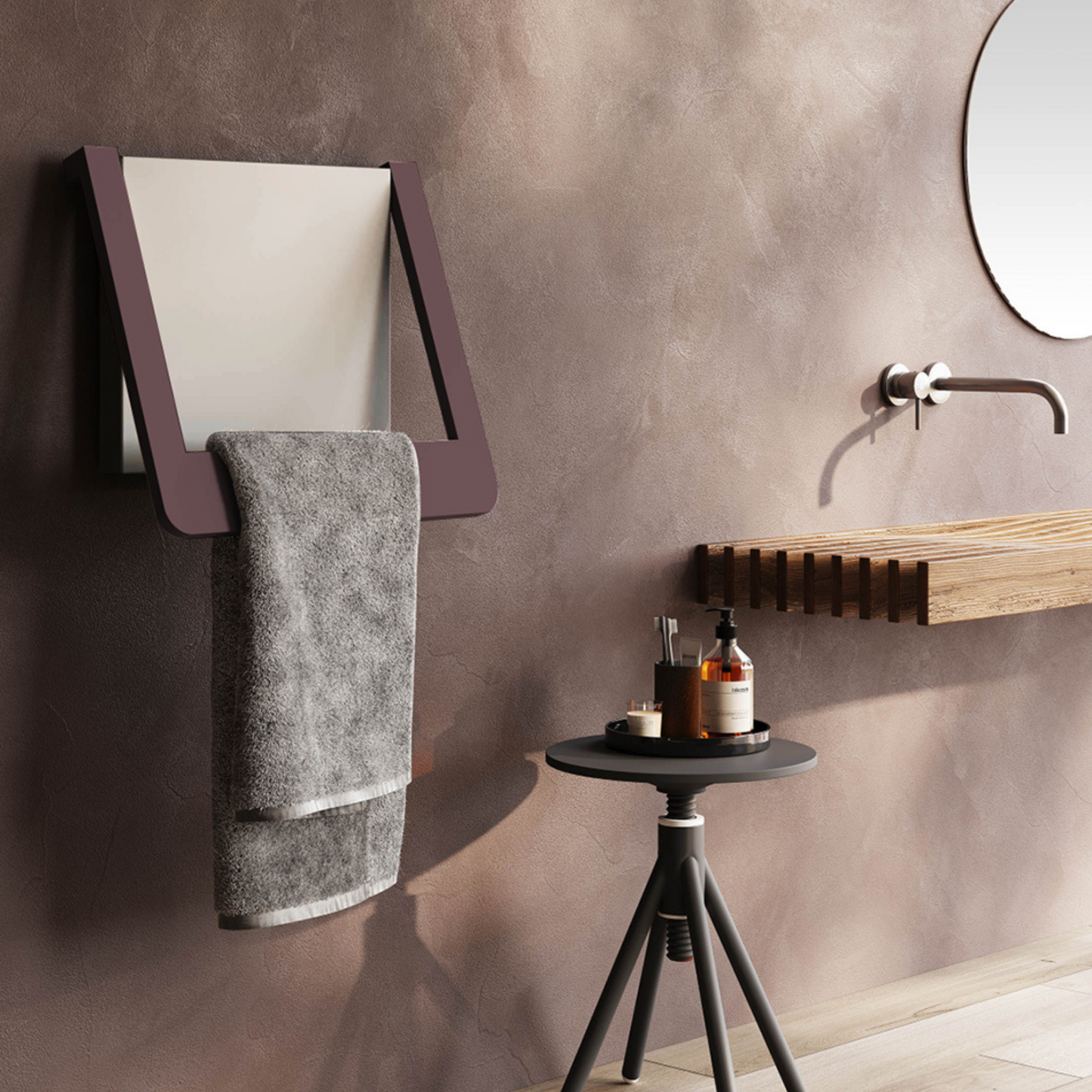 Bathroom setting with a towel rack, mirror, and small table with items on a beige wall.