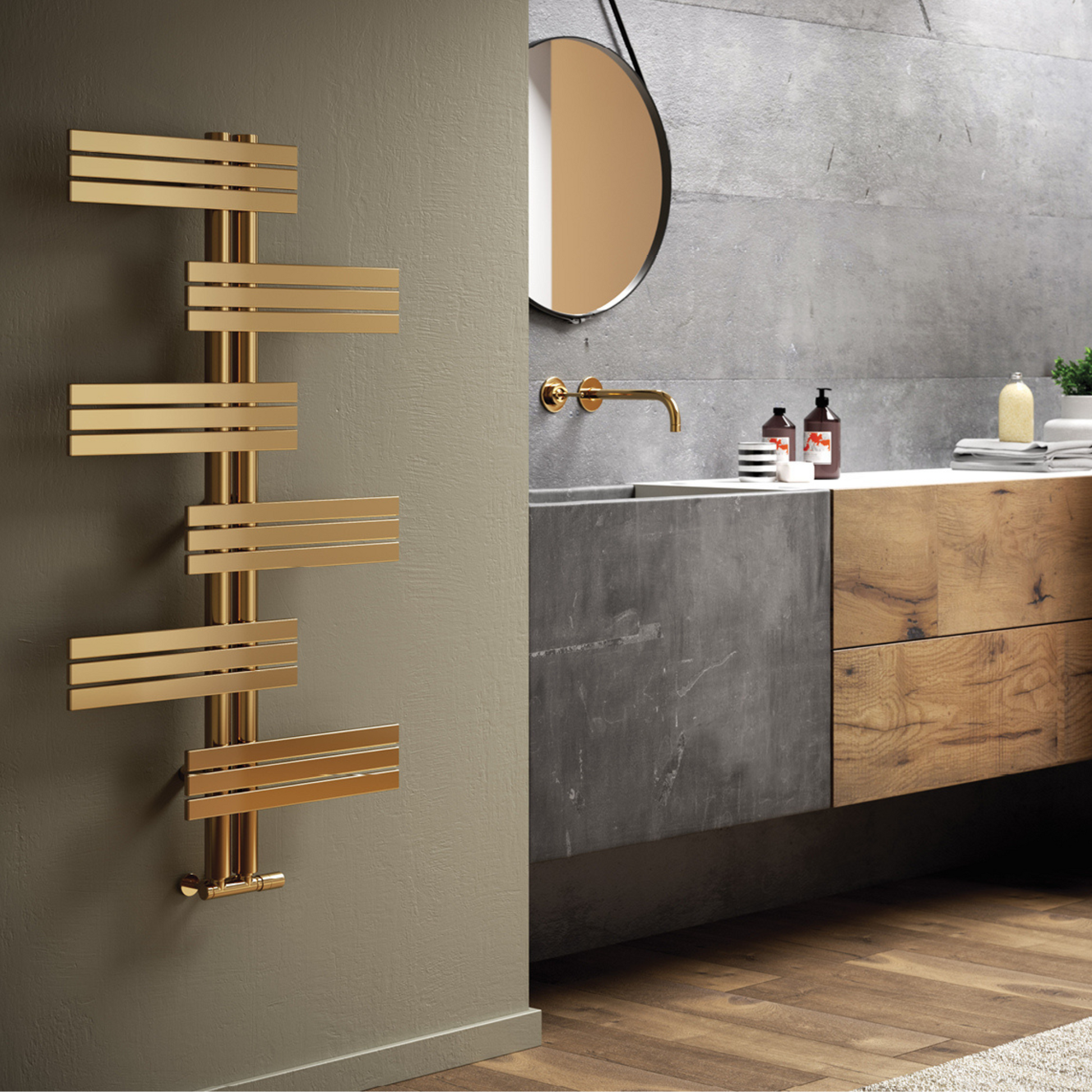 The Babyla gold-toned stainless steel hot water towel warmer mounted on a wall with multiple horizontal bars, positioned in a bathroom setting.