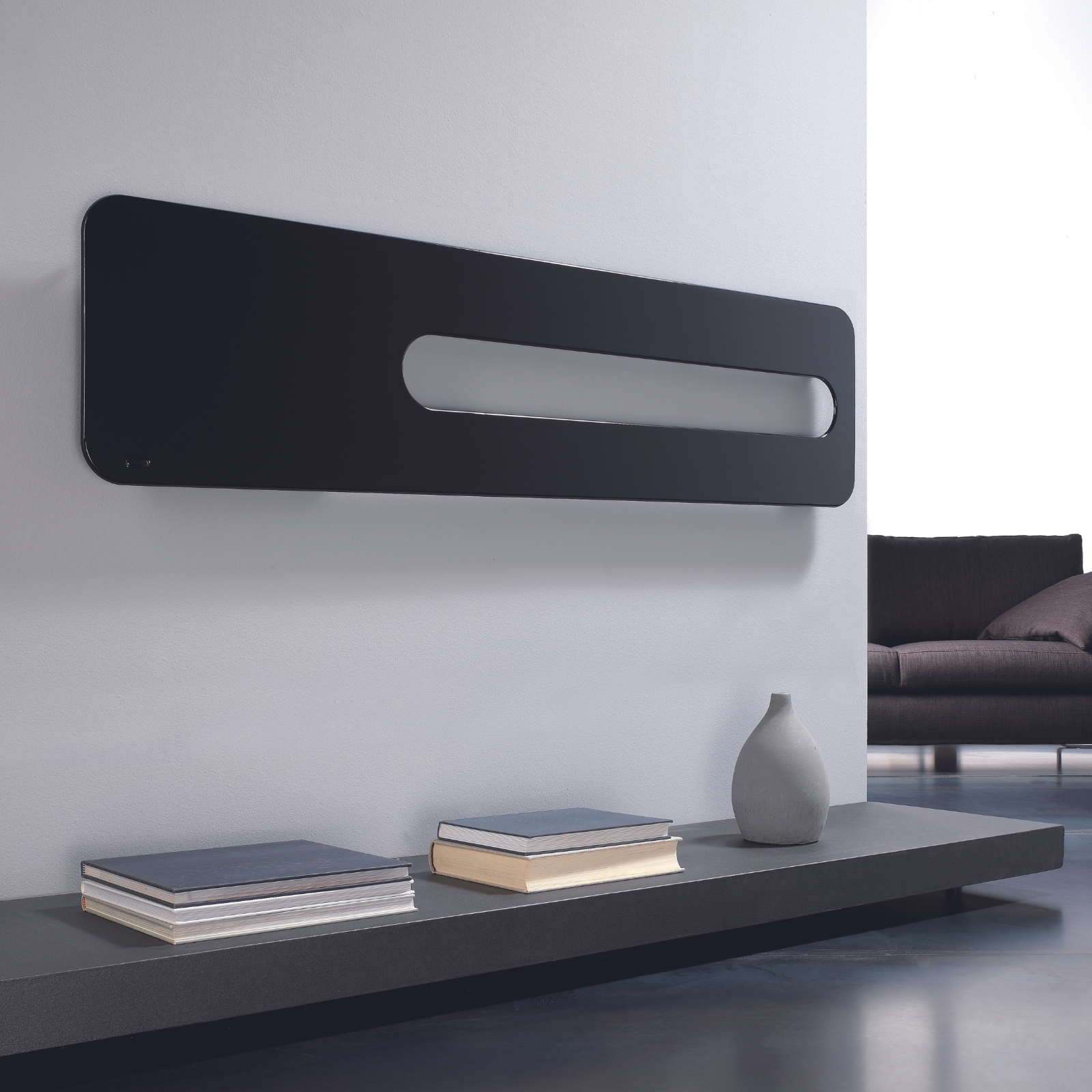 Modern living room with a black wall-mounted radiator and a gray sofa.