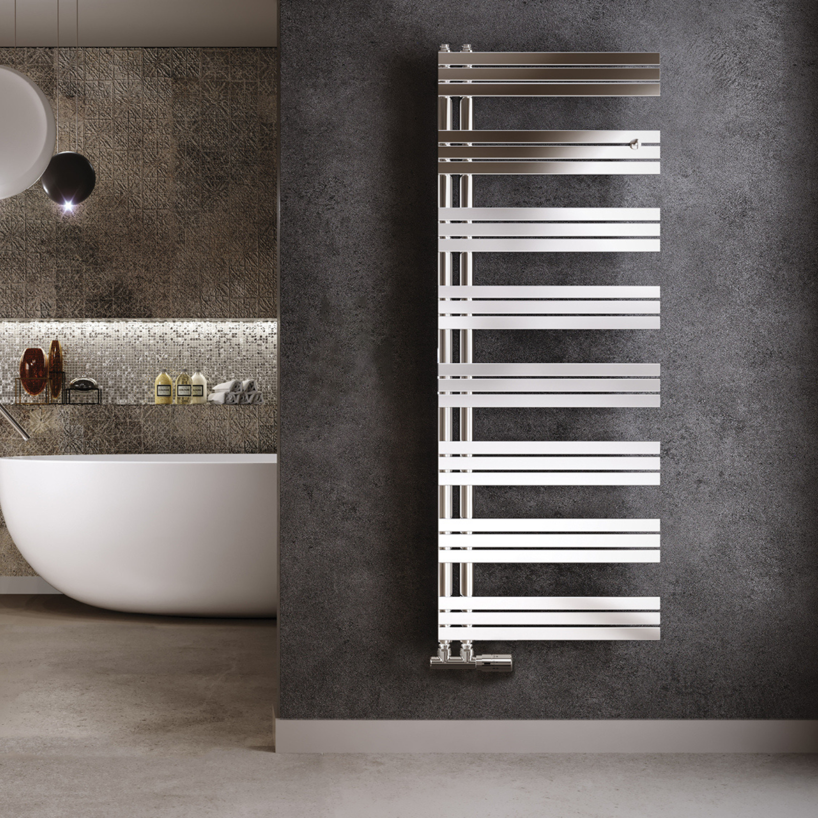 A polished stainless steel vertical towel warmer with multiple horizontal bars, placed in a modern bathroom setting with a dark grey wall and a white bathtub.