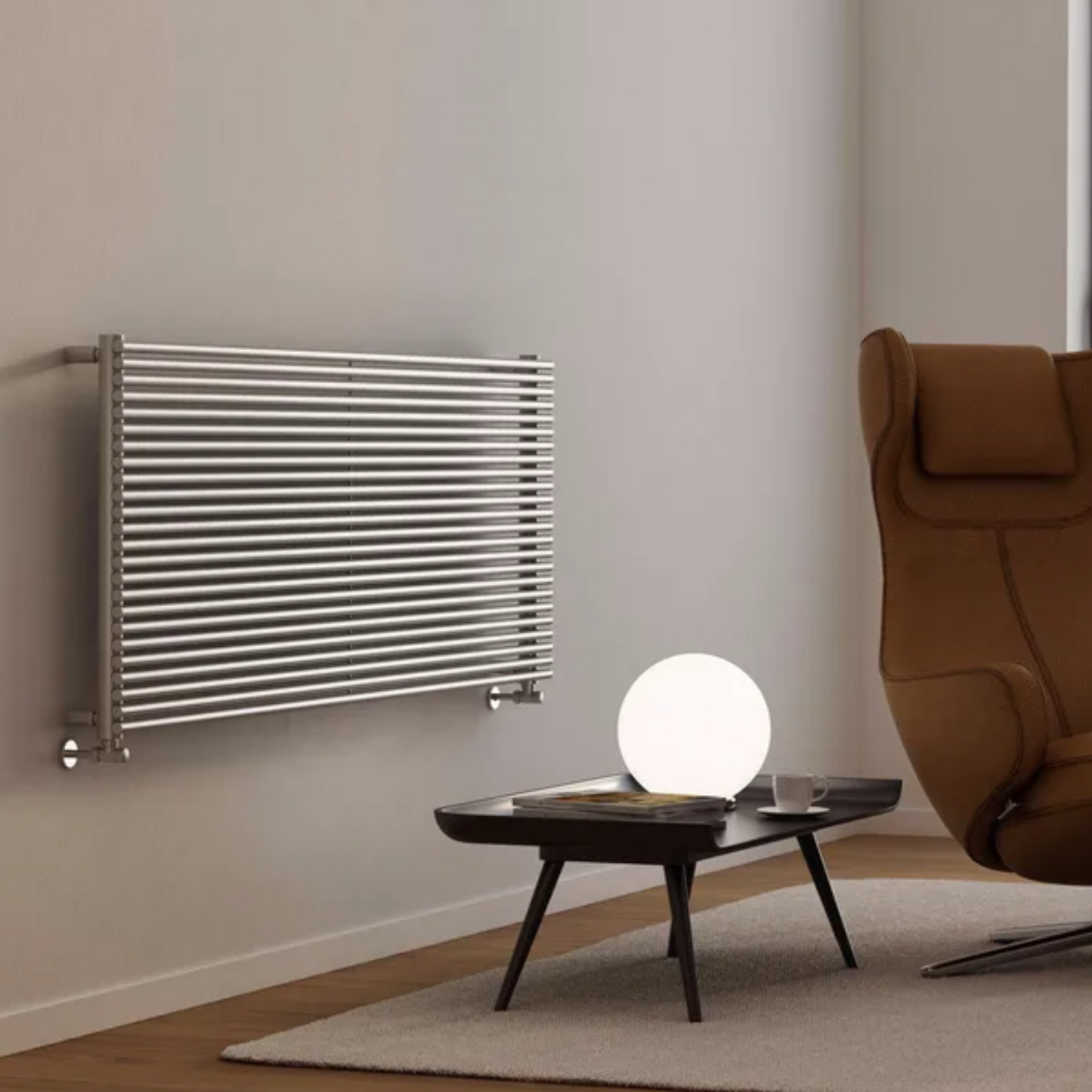 Modern room with a Stainless Steel radiator on the wall and a brown armchair.