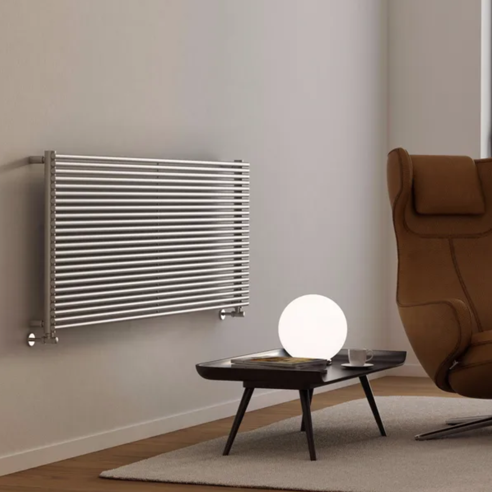 Modern room with a Stainless Steel radiator on the wall and a brown armchair.