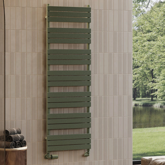 Green towel radiator mounted on a tiled wall with a view of trees and water outside.
