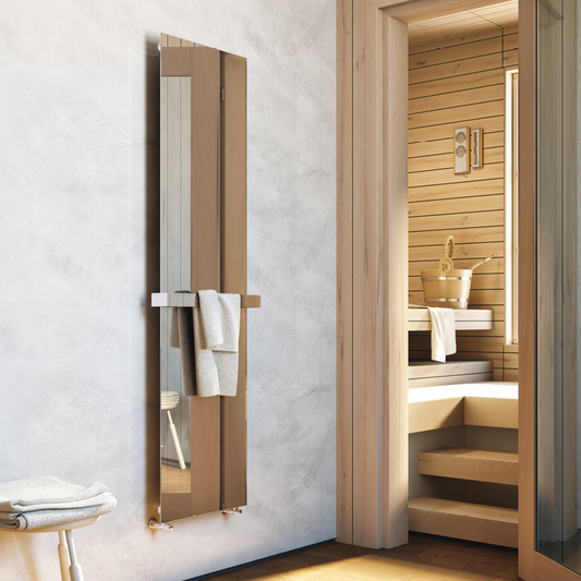 A vertical hot water radiator made of stainless steel with a minimalist design, mounted in a bathroom setting, featuring a towel bar on the side.