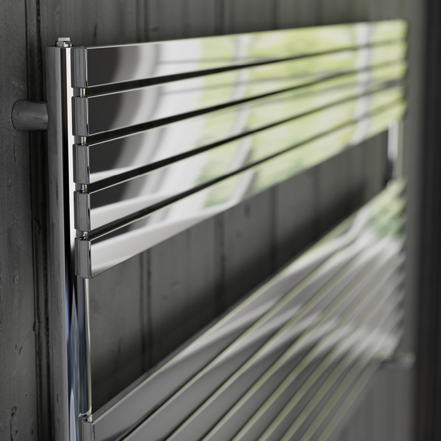 Metallic towel rack on a dark wooden wall