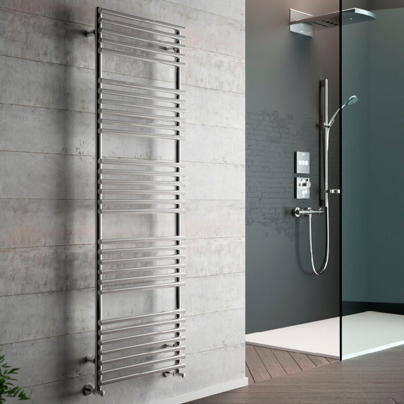 Towel radiator mounted on a tiled wall next to a shower setup.