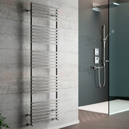 Towel radiator mounted on a tiled wall next to a shower setup.