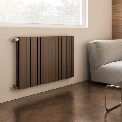 Modern radiator on a wall next to a sofa in a room with a window
